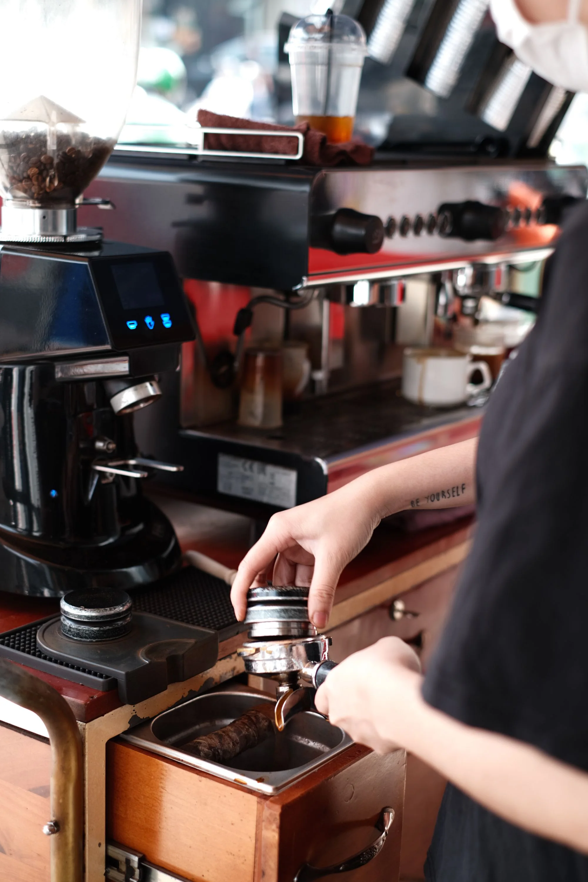 Barista bereitet Espresso an einer professionellen Kaffeemaschine zu. Stimmungsbild.